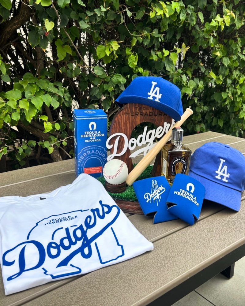 Promotional merchandise flat lay featuring Dodgers and Tequila Herradura branded apparel, hats, and koozies